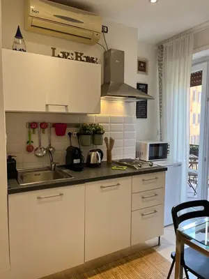 a kitchen with white cabinets and a sink at Vatican Loft a pochi passi da piazza San Pietro in Rome