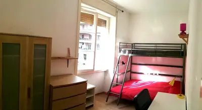 a bedroom with a bunk bed and a window at Camera Privata Nomentana per medio lungo periodo in Rome