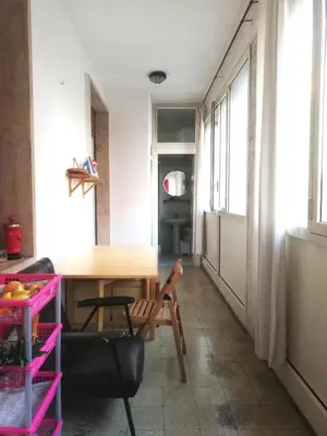 a dining room with a table and a chair at Camera Privata Nomentana per medio lungo periodo in Rome
