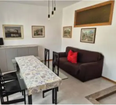 a living room with a table and a couch at Il Colosseo Holiday home in Rome