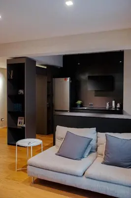 a living room with a couch and a kitchen at Roma Urban Retreat in Rome