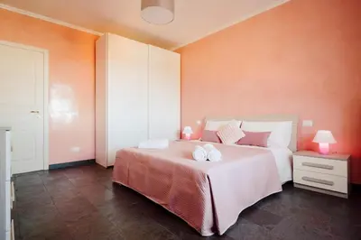 a bedroom with a bed with two towels on it at Dream Vacation Suites in Rome