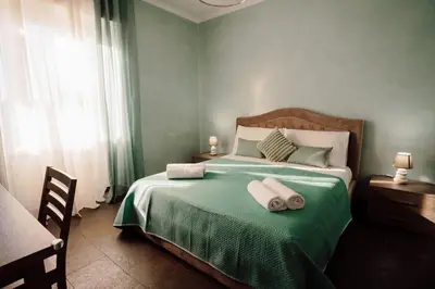 a bedroom with a bed with two towels on it at Dream Vacation Suites in Rome