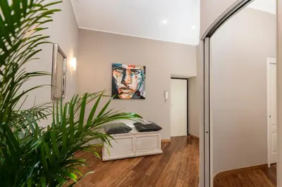 a hallway with a painting on the wall and a plant at Maisondesfleurs in Rome