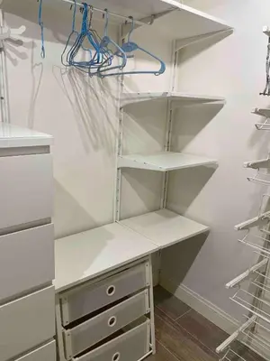 a walk in closet with white shelves and a desk at Rome City Center Apartment in Rome