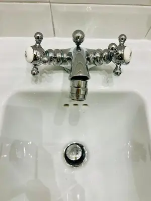 a bathroom sink with a silver faucet at Julie's Renovated View in Rome