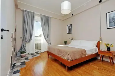 a bedroom with a bed and a large window at Julie's Renovated View in Rome