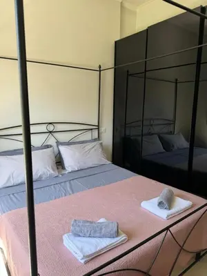 a bedroom with two beds with towels and a mirror at Mila House in Rome