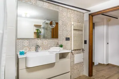 a bathroom with a sink and a mirror at iFlat Campo de Fiori's Comfy Gem in Rome