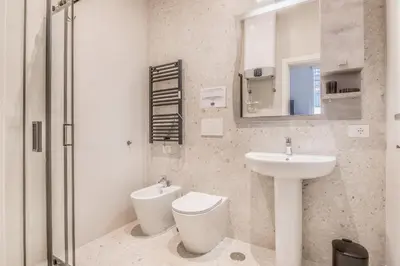 a bathroom with a toilet and a sink at Via Nizza 126 Luxury in Rome