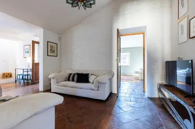 a living room with a couch and a tv at Attico Spazioso ed Elegante a Santa Maria Maggiore in Rome