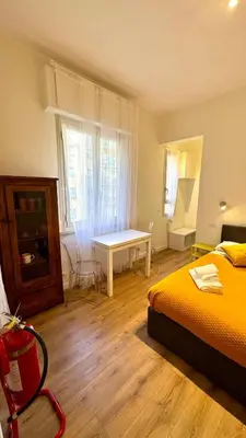 a bedroom with a bed and a table in it at Matilda House San Paolo Roma in Rome