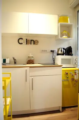 a kitchen with white cabinets and a yellow refrigerator at Matilda House San Paolo Roma in Rome