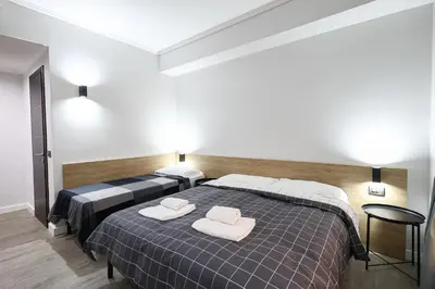a bedroom with two beds with towels on them at Seven Kings Relais in Rome