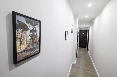 a hallway with a painting hanging on a wall at Seven Kings Relais in Rome