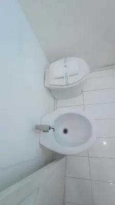 a white bathroom with a toilet and a sink at apt via cernaia rome center in Rome
