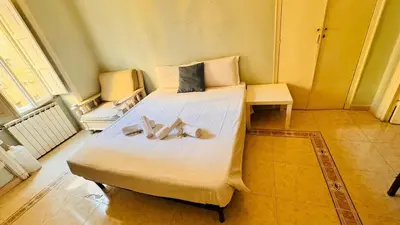 a bedroom with a large bed with two bow ties on it at apt via cernaia rome center in Rome