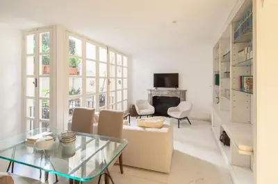 a living room with a glass table and chairs at Maison Barchetta in Via Giulia in Rome