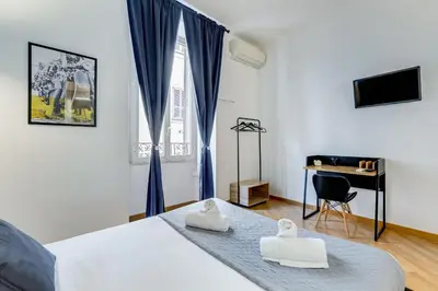 a bedroom with a bed with two towels on it at VIVILO COLLECTION - Marche 54 Apart 4bdr - Close to Via Veneto in Rome
