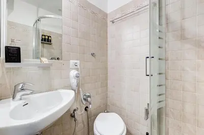 a bathroom with a sink and a toilet at VIVILO COLLECTION - Marche 54 Apart 4bdr - Close to Via Veneto in Rome