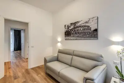 a living room with a couch and a picture on the wall at Vatican Private Apartment in Rome
