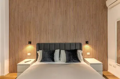 a bedroom with a large bed with two night stands at Vatican Private Apartment in Rome
