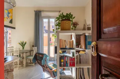 a room with a book shelf filled with books at Casa Emma - Charme Holidays in Rome