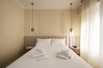 a bed with two white towels on top of it at Eudora Guesthouse Roma in Rome
