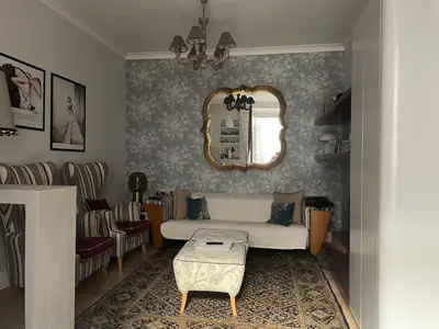 a living room with a couch and a mirror at La casa di Nina in Via Veneto in Rome