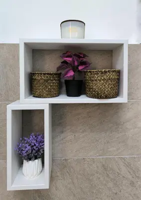 two plants in baskets on a shelf with flowers at Crezy House Trilussa in Rome