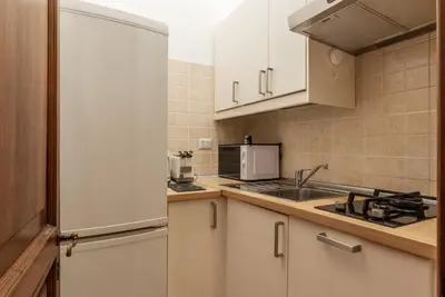 a kitchen with white cabinets and a sink at GuestHost - Charming Apartment near Piazza di Spagna in Rome