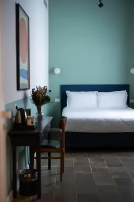 a bedroom with a bed and a table with a chair at Interno 12 in Rome