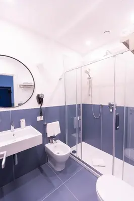 a bathroom with a shower and a toilet and a sink at Interno 12 in Rome