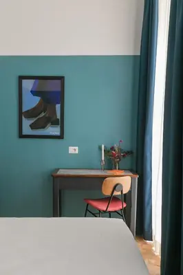 a bedroom with a desk and a table with a chair at Interno 12 in Rome