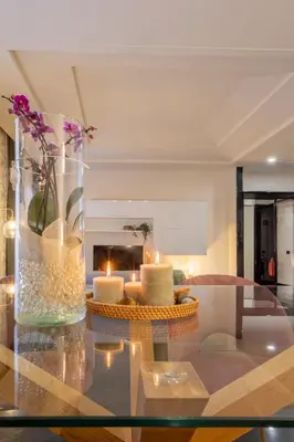 a living room with a glass table with candles on it at Morgana - Charming Apartment Close to Vatican in Rome