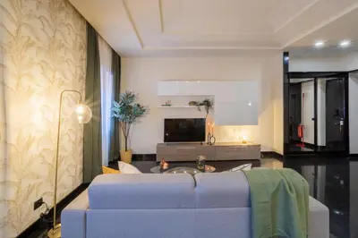 a living room with a couch and a tv at Morgana - Charming Apartment Close to Vatican in Rome