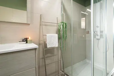 a bathroom with a glass shower and a sink at Morgana - Charming Apartment Close to Vatican in Rome