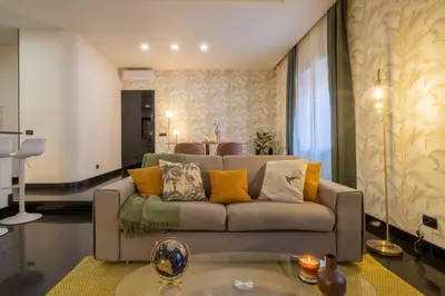 a living room with a couch and a table at Morgana - Charming Apartment Close to Vatican in Rome