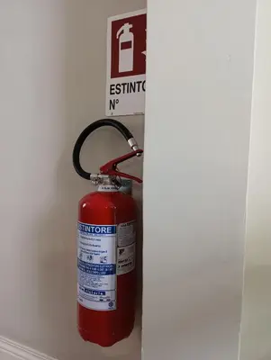 a red fire hydrant hanging from a wall at Trastevere Bertani MiniApartment in Rome