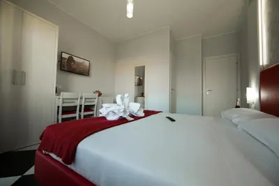 a bedroom with a large bed with a red and white blanket at Love of Rome in Rome