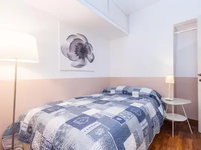 a bedroom with a bed with a blue and white blanket at Spacious 2BR in the historic center in Rome