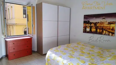 a bedroom with a bed and a painting on the wall at Come' Na Vorta Apartment in Rome