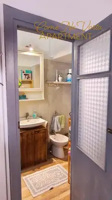 a bathroom with a toilet and a sink at Come' Na Vorta Apartment in Rome