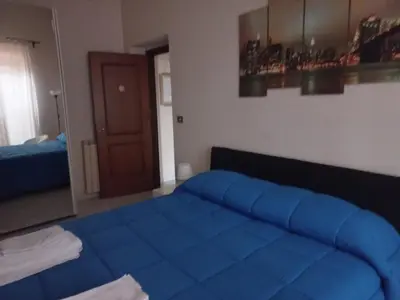a bedroom with a blue bed in a room at tommy's house in Rome