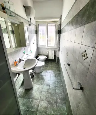 a bathroom with two toilets and a sink at Da Zia Elena in Rome
