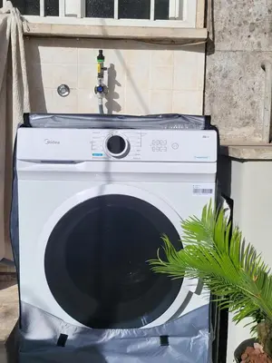 a white washing machine sitting in a box with a plant at Da Zia Elena in Rome