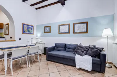 a bedroom with a large bed with blue walls at Coliseum Rome Apartments in Rome