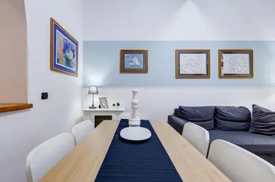 a bedroom with a large white bed and a closet at Coliseum Rome Apartments in Rome