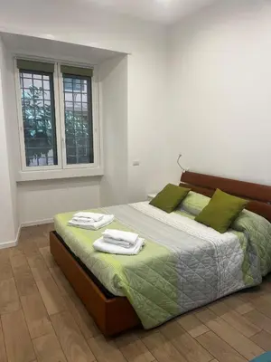 a bedroom with a bed with two towels on it at DomuSolina in Rome