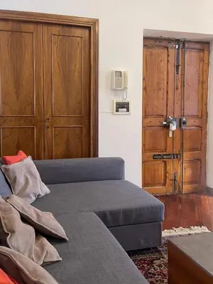 a living room with a couch and a door with a door at La Casa di Pina in Rome